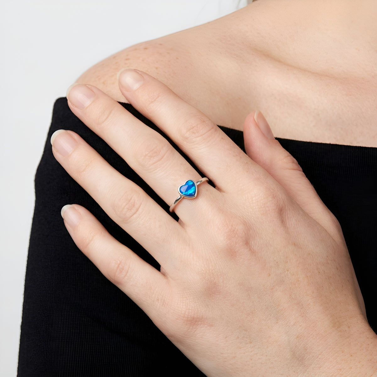 Heart of Fire Opal-Ring getragen, Herz in 925 Silber mit blauem Opal (Triplette), Nahaufnahme an der Hand